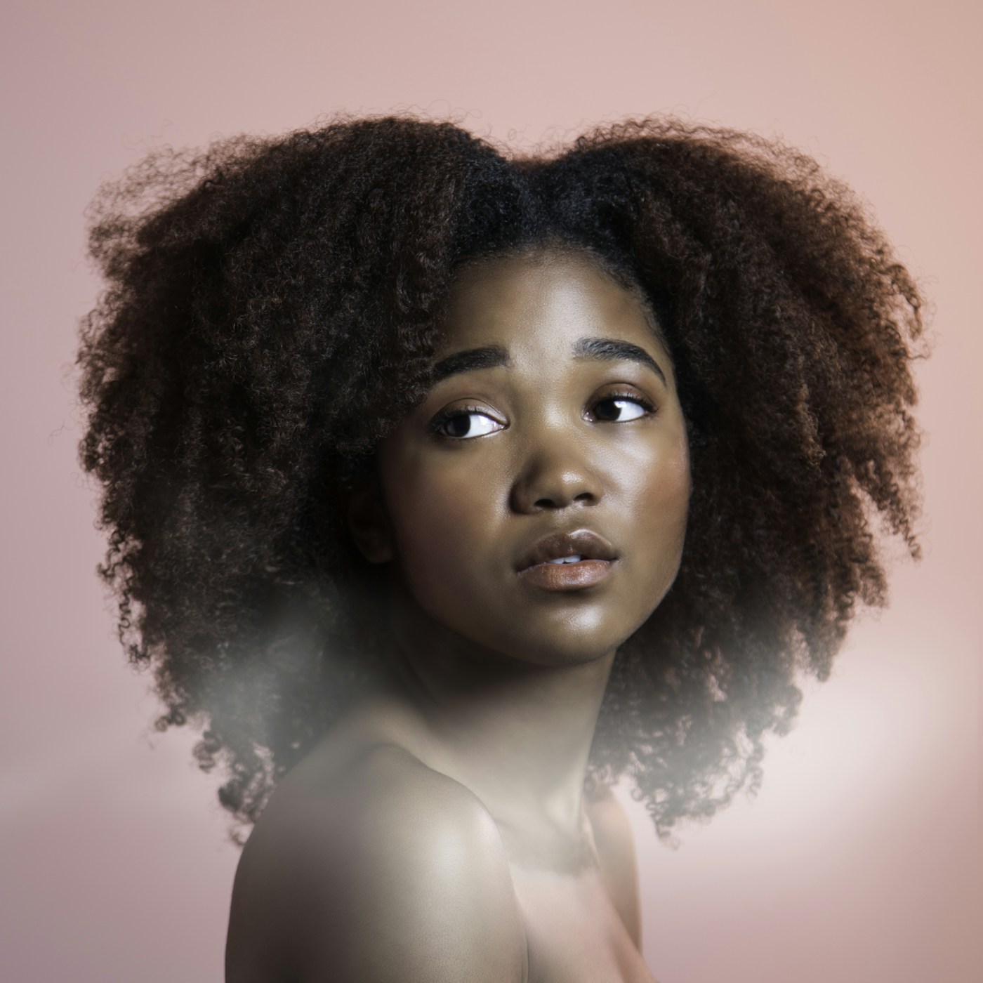 Editorial portrait with soft curls, used as hairstyle inspiration rather than a product photograph